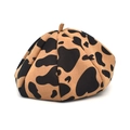 Detailed top view of wool felt beret featuring a stylish dark cow print pattern - M (56-58cm) / Camel