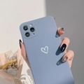 Detail of matte blue iPhone case with a white heart pattern held by hand in soft light - Series 7/8/SE 2020 / Slate Blue Heart
