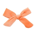 Close-up of coral velvet hair bow showing soft plush texture and handcrafted central knot - No.6 Ivory
