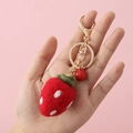 Handcrafted red wool felt strawberry keychain with golden hardware on pink background - Animal Keychain / Big Strawberry
