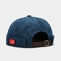 Detail of blue corduroy docker cap with red patch and adjustable leather strap - M (56-58cm) / Navy Blue