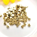 Close-up of small 14K gold filled heart-shaped spacer beads for DIY jewelry making - Heart 6x5mm / 14K Gold Plated