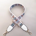 Detail of adjustable embroidered floral bag strap with gold metal hooks and PU leather ends - Blue Circles + White Leather