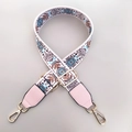 Close-up of a wide fabric bag strap with blue floral patterns and pink leather ends - Blue Circles + Pink Leather