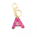 Porte-clés lettre A en résine rose avec paillettes et accessoires dorés brillants - Paillettes Roses / Lettre A