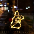 Hanging LED snowman silhouette light with warm yellow bulbs for Christmas window display - Snowman