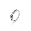 Elegant 8-shaped titanium steel ring with zirconia inlays on a clean white background - Steel