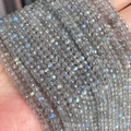 Faceted grey labradorite beads featuring vibrant blue and gold iridescent flashes - Labradorite 3mm