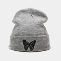 Close-up of grey knitted beanie featuring detailed black butterfly embroidery on the cuff - M (56-58cm) / Gray
