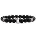 Macro shot of black volcanic stone beads with a silver crown charm and metal spacers - Lava Stone Silver Crown