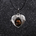 Macro detail of angel wing pendant with tiger eye stone on black cord necklace - Brown (Tiger Eye)