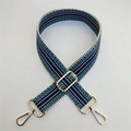 Close-up of ethnic geometric pattern wide strap with polished gold-tone metal hooks - Gold Buckle / Blue