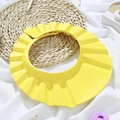 Yellow baby shower cap with adjustable strap and wide brim for hair washing safety - Yellow