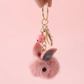 Pink plush bunny keychain with metal hook and small bell on a soft pink background - Animal Keychain / Pink Rabbit