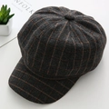Detail shot of grey checked wool newsboy cap with orange stripes on white desk - M / Plaid Style / Plaid Grey
