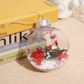 Transparent Christmas bauble with red stars and green pine needles on wooden table - Style A (Red Stars & Pine)