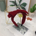 Elegant red velvet double layered bow headband on a decorative shelf with pearls - Red