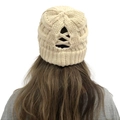 Detail of beige cable knit beanie with messy bun ponytail cross-back opening - Beige