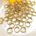 Polished 14k gold-filled jump rings for jewelry making on a white ceramic plate - Outer Diameter 6mm / 14K Gold
