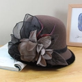 Close-up of wool cloche hat with floral mesh decor and red feathers on a wooden table - Two-Tone Mesh Flower Style / Dark Coffee