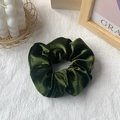 Elegant dark green velvet scrunchie hair tie on minimalist textured background - Grass Green