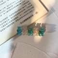 Detail of five holographic gummy bear hair clips on a golden metal base with glitters - Light Blue + Jelly Milk