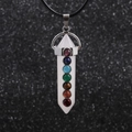 Macro shot of hexagonal white crystal chakra pendant with seven colored gemstones - White Crystal Pillar - Wax Cord