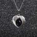 Stainless steel angel wing heart necklace with blue gemstone on black background - Blue Sandstone
