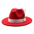 Detail of red wool felt fedora featuring a white ribbon and natural decorative feathers - Adjustable / Red