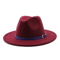 Detail of burgundy felt fedora hat featuring a slim blue band and golden metal buckle - Burgundy