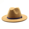 Close-up of camel wool fedora with navy blue leather band and gold metal buckle detail - Camel
