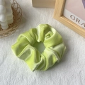 Lime green velvet scrunchie hair tie on wooden background with cozy aesthetic - Light Green