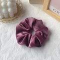Dark purple velvet scrunchie hair tie on white linen background with minimalist decor - Lavender