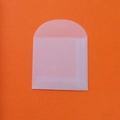 Blank translucent tracing paper envelope with round flap on orange textured background - 5*5cm