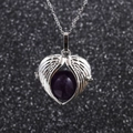 Macro view of silver angel wings heart pendant with purple amethyst bead and chain - Purple Crystal