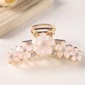 Pink blossom hair claw clip with crystal accents and golden metallic finish for women - White