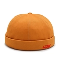 Close-up of red Fairy embroidery on orange cotton twill brimless docker cap - Yellow