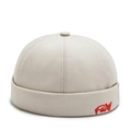 Close-up of beige docker hat showing detailed red Fairy embroidery and twill cotton fabric - Beige