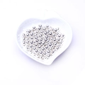 Polished silver round spacer beads for jewelry making displayed in a heart ceramic dish - Silver