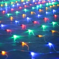 Detailed view of waterproof multicolor LED net lights spread on the ground for festive decor - 6x4m 868LEDs (With Tail Plug) / Colorful