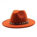 Detail of orange wool fedora hat featuring a leopard print band and metal buckle - Rust red