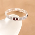 Detail of silver bangle with white pavé diamonds and red gemstones on white plate - Rhinestone With Red Gem Accents (Style 3)