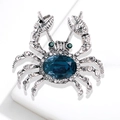 Silver crab brooch with deep blue gemstone and sparkling crystals on white background - Silver Tone Deep Blue Gemstone