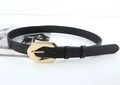 Detail of a black leather belt with a large golden buckle on a white background - Black
