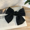 Classic large black ribbon bow hair clip with spring barrette on vintage newspaper background - Spring Clips / Black