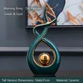 Modern abstract ceramic sculpture in deep green with a golden sphere for home decor - Morning Song Tall Style Green Gold - Large