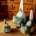 Three-piece set of green hand-painted wooden cat figurines with white daisy patterns - Set of 3