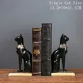 Pair of black Egyptian Bastet cat goddess bookends with gold accents on wooden desk - Egyptian Cat Bookends-Black (Pair)