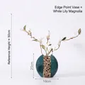 Elegant dark green ceramic vase with golden floral relief and white magnolia bloom decor - Yuandian Vase + White Magnolia