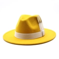 Detail of a bright yellow wool fedora hat with white ribbon and feather accessories - Adjustable / Yellow